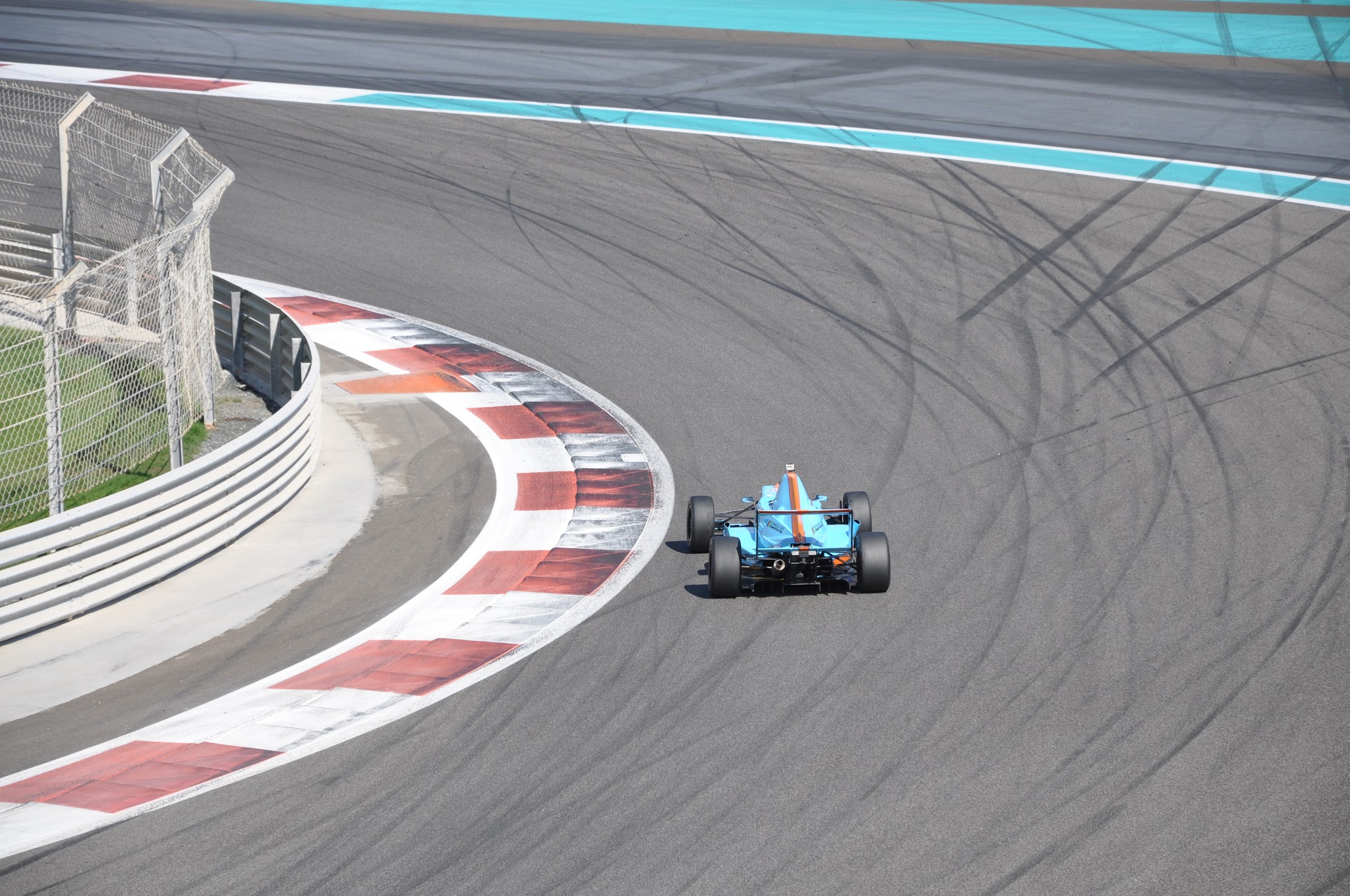 Blue Gulf-liveried car cornering