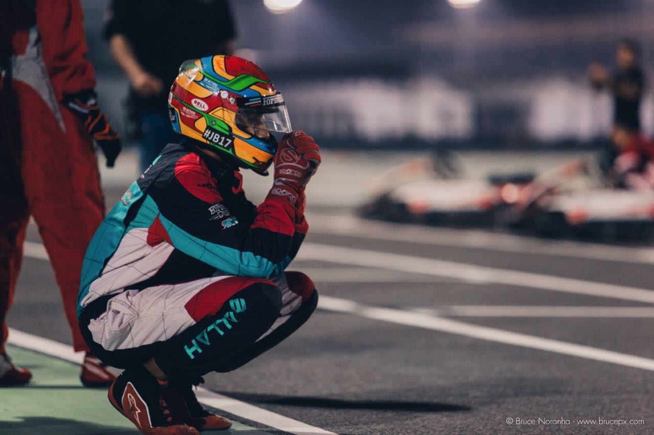 Kneeling in the pit lane under lights